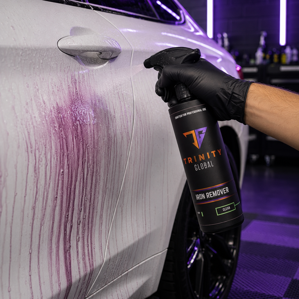 Person using a Trinity Global Iron Remover spray on a car's surface